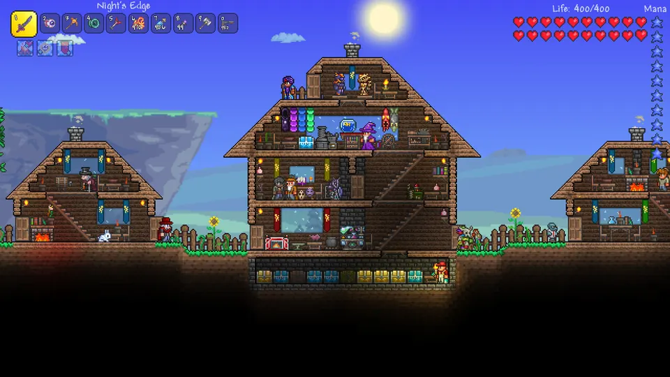 A multi-storey wooden Terraria base with furnished rooms beneath a blue sky